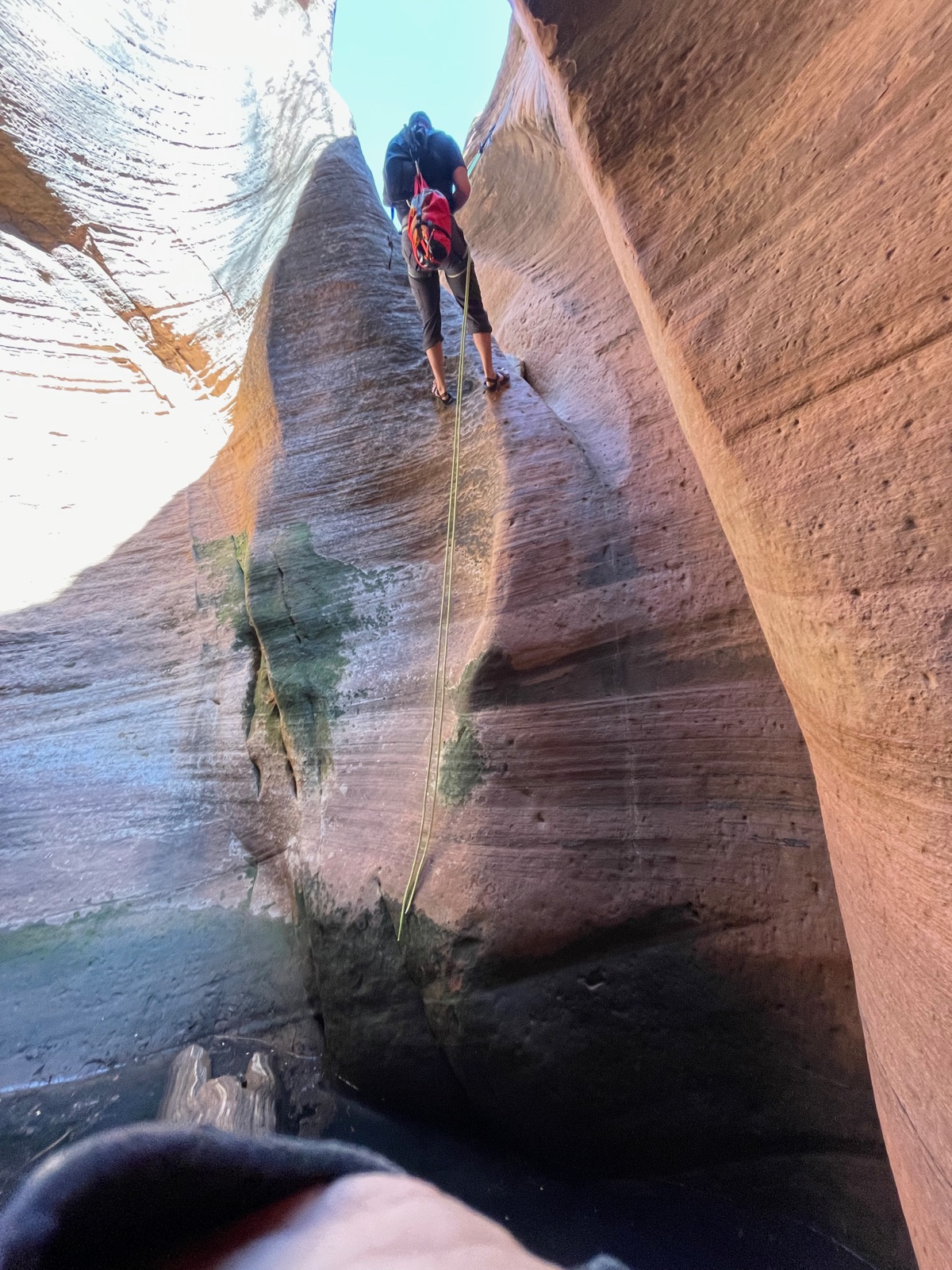 Rappelling into a sandstone slot canyon