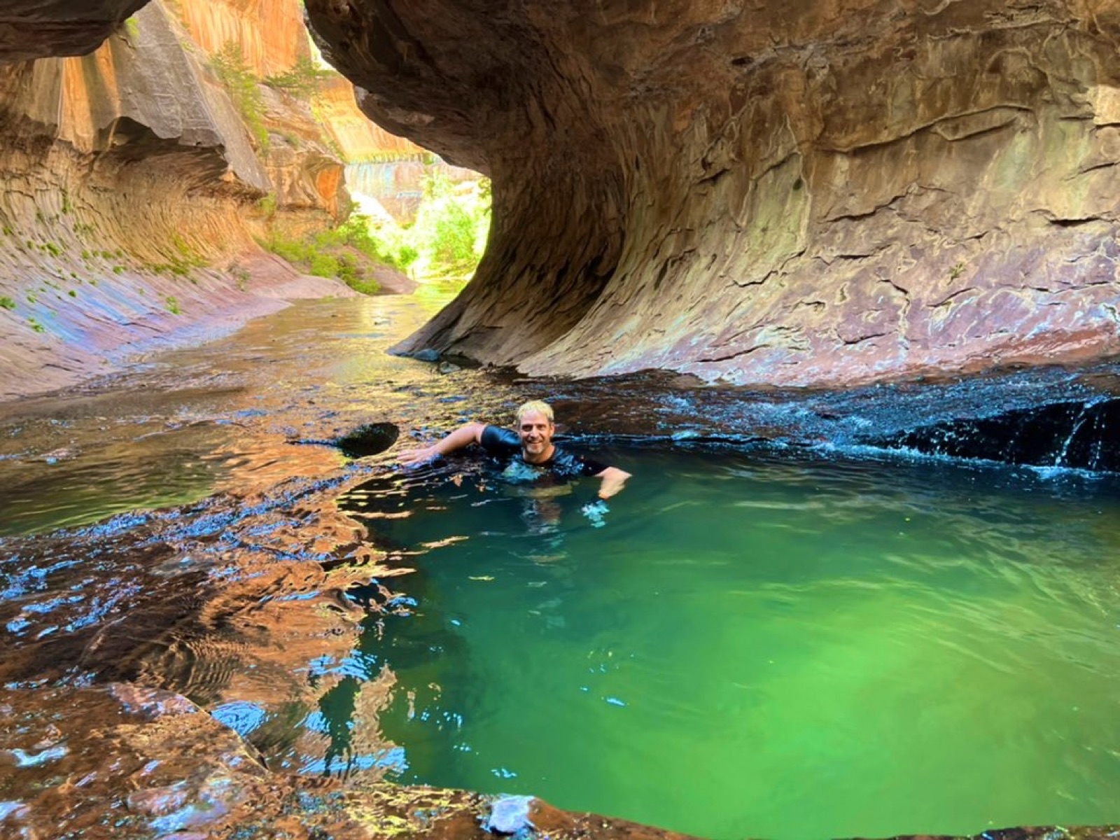 Swimming through an emerald pool in the Subway, Zion